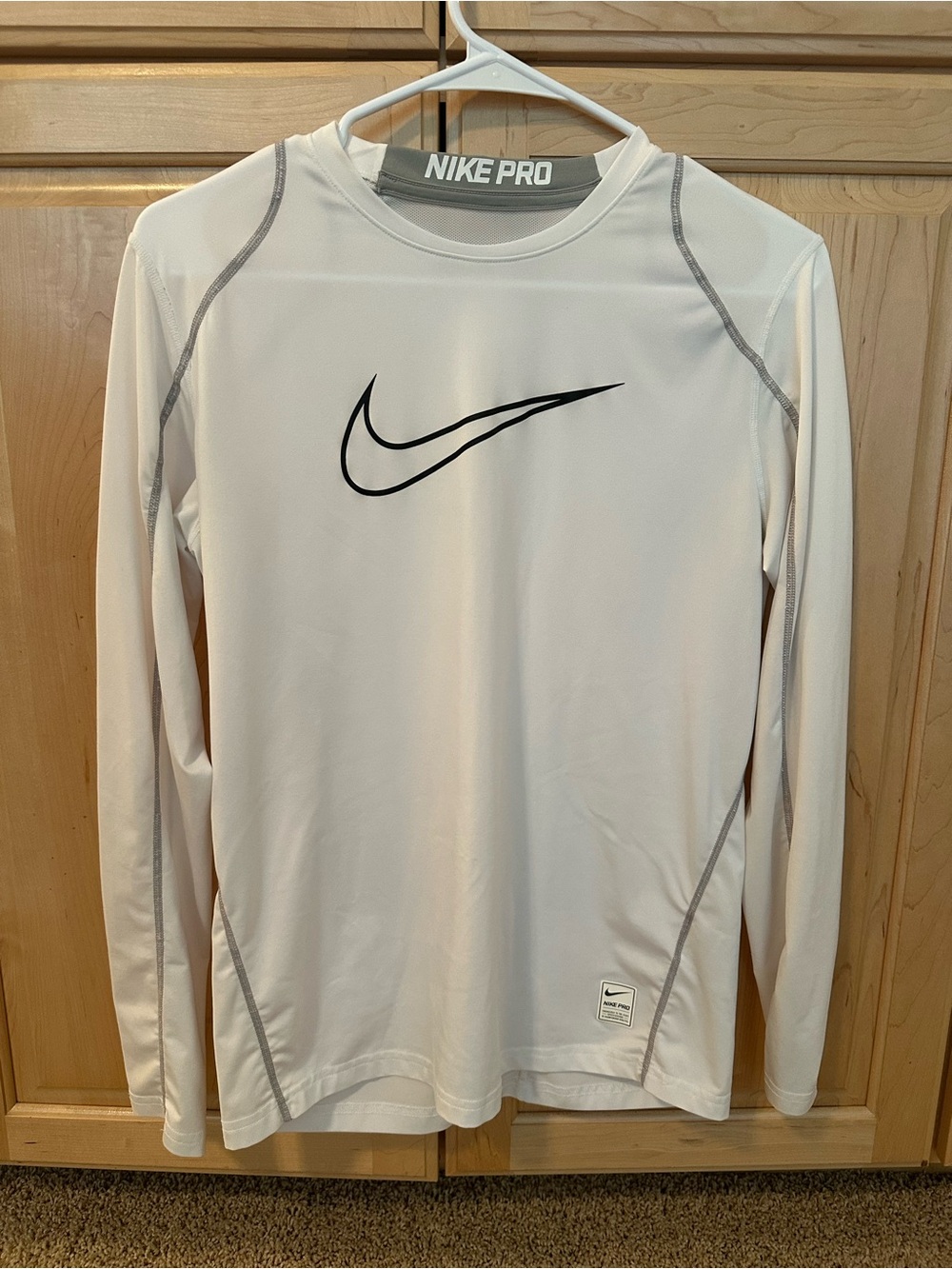 Nike White Long Sleeve Loose fit Athletic Top with Black Swoosh